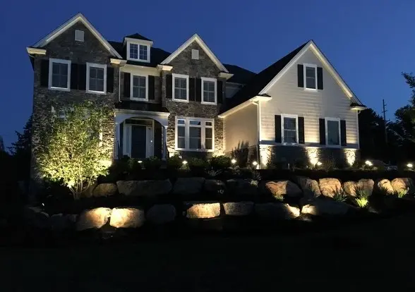 a house beatifully lit with newly installed landscape lighting